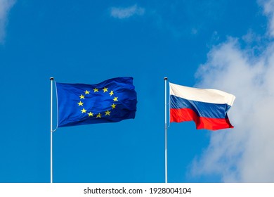 EU Flag And Russia Flag Are On Blue Sky. Concept Relations Between Europe And Russia