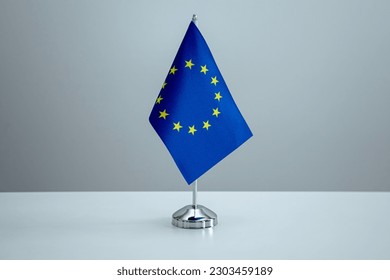 EU flag in a stand on table - Shutterstock ID 2303459189