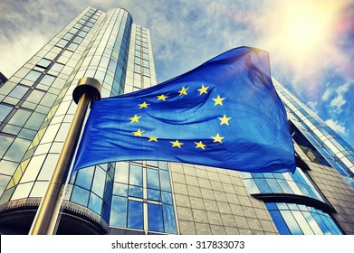 EU flag waving in front of European Parliament building. Brussels, Belgium