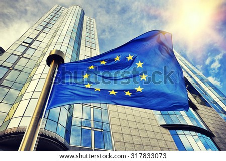 EU flag waving in front of European Parliament building. Brussels, Belgium
