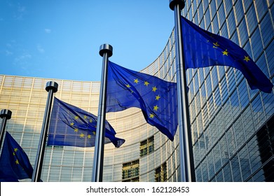 EU flags in front of European Commission in Brussels - Shutterstock ID 162128453