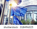 EU flags waving in front of European Parliament building. Brussels, Belgium