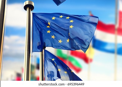 EU Flags Waving In Front Of European Parliament Building. Brussels, Belgium