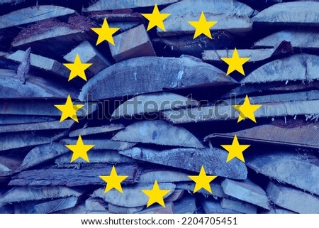Eu stars against a stack of firewood. The concept of rising fuel prices, firewood due to energy crisis