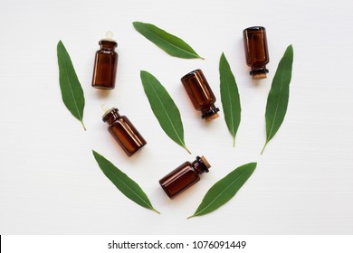 Eucalyptus Oil Bottle With  Leaves On White Background.