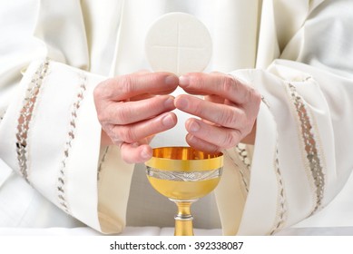 Eucharistic communion and hands Priest - Shutterstock ID 392338087