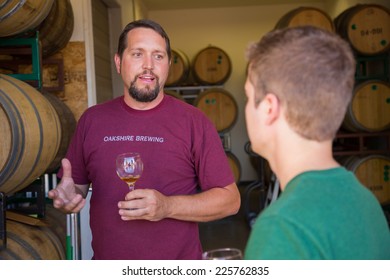 EUGENE, OR - JULY 17, 2014: Master Brewer And Employee Sampling And Tasting Limited Edition Bourbon Barrel Aged Beers At Oakshire Brewing.