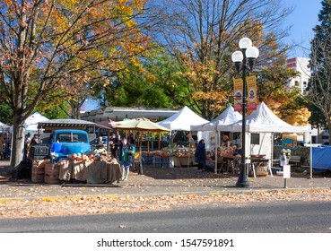 Eugene, OR, 10/29/19: Farmers Market Customers And Vendors Mingle With Produce And Old Truck On Display On A Sunny Fall Day In Downtown