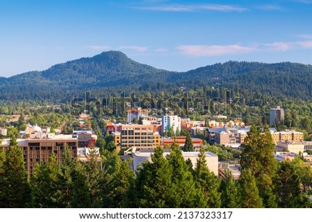Eugene, Oregon, USA downtown cityscape and mountains in the afternoon.