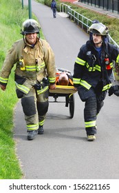 Eugene, Oregon, USA Â?Â? May 2, 2012: Eugene, OR Emergency Services And National Guard Work In A Disaster Response Drill. The Unidentified Firemen Are Transporting Unidentified Injured To Landing Zone.