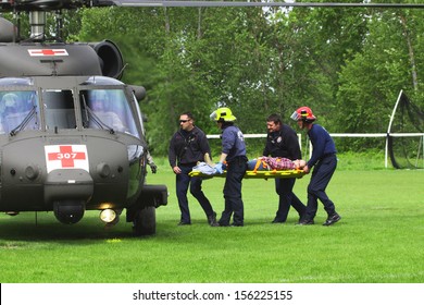 Eugene, Oregon, USA Â?Â? May 2, 2012: Eugene, OR Emergency Services And National Guard Work In A Disaster Drill. Unidentified Firemen Carried Injured Person To Load On Helicopter.