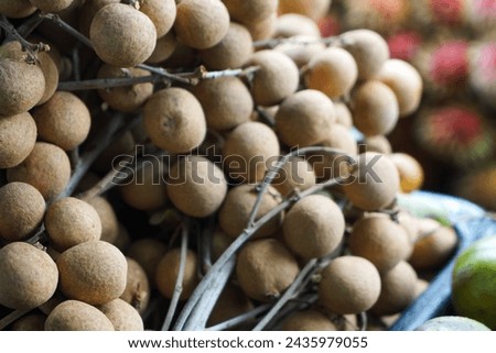  Euphoria malaiense (Sapindaceae) or buah mata kucing at a fruit stall.  Selective focus