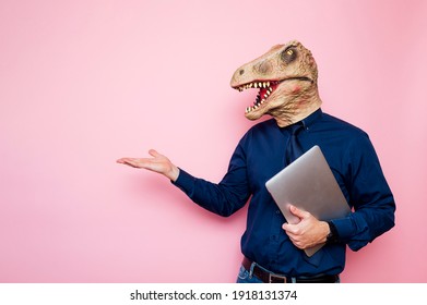 Euphoric Man With Dinosaur Head Using Laptop