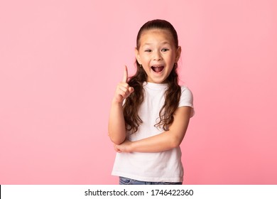Eureka. Excited asian child having excellent idea, pointing up with finger, isolated over pastel pink studio wall, copyspace - Shutterstock ID 1746422360