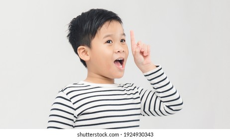 Eureka! Portrait Of Smart Little Boy Pointing Finger Up And Looking Inspired By Genius Thought, Showing Good Idea Sign