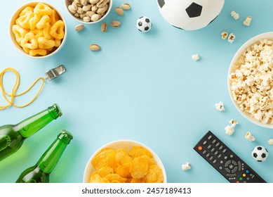 Euro 2024 snack scene: Assorted goodies for soccer fans! From chips to popcorn, crisps to pistachios, ice-cold beer and more. Top view on a pastel blue backdrop, perfect for ads or messages - Powered by Shutterstock