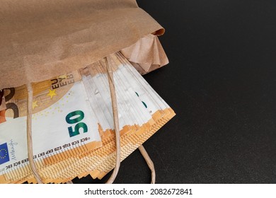 Euro banknotes. Cash in a paper bag on the table. The concept of corruption and illegal money - Shutterstock ID 2082672841