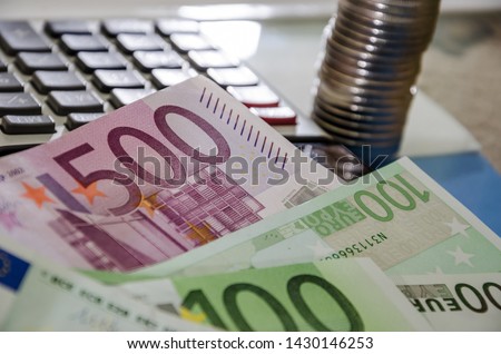 euro banknotes, coins and calculator, close-up