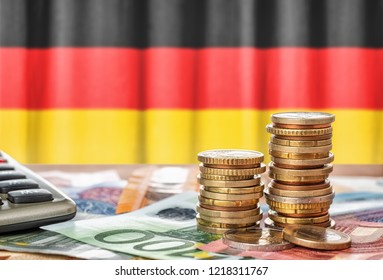 Euro banknotes and coins in front of the national flag of Germany - Powered by Shutterstock