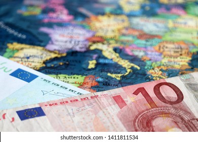 Euro banknotes on the map of Europe, selective focus. Concept for european economy, eurozone countries - Powered by Shutterstock