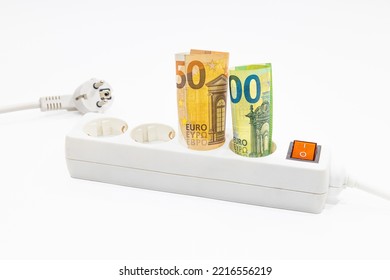 Euro Banknotes Are Stuck In An Electric Power Strip. Concept Of Rising Electricity Prices