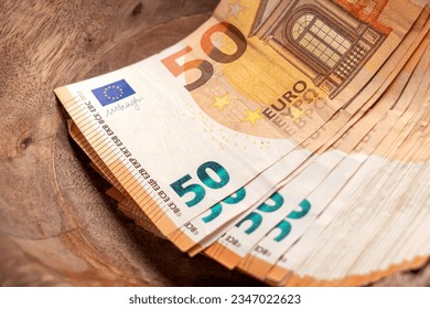 Euro banknotes in vintage wooden container. Concept saving money