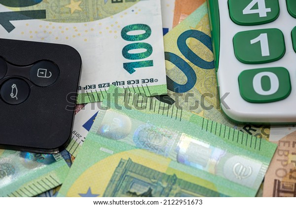 euro bills and a car key. auto investment insurance.\
concept of sale or rent