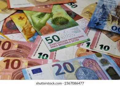 Euro cash and swiss cash. Many Euro banknotes and swiss banknotes of different values. Euro and swiss cash background. - Shutterstock ID 2367086477
