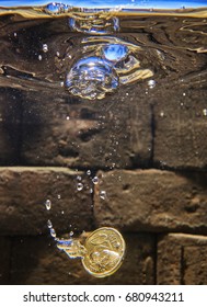 Euro Coin Falling In A Wishing Well.