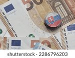 euro coin with national colorful flag of slovakia on the euro money banknotes background