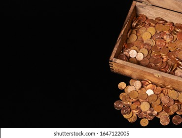 Euro coins in chest on black backgrtound. View from top.