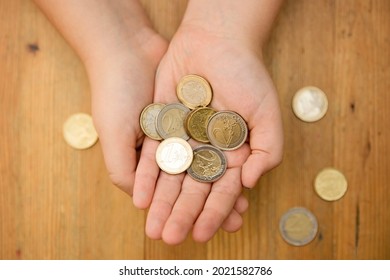 Euro Coins In Kids Hands. Currency Transfer, Investment, Payment, Donation, Gift Concept. Saving Money For The Future, Education, Car, Weddings. 