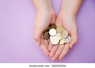 Euro Coins In Kids Hands. Currency Transfer, Investment, Payment, Donation, Gift Concept. Saving Money For The Future, Education, Car, Weddings. 