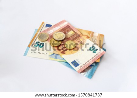 Euro coins lie on the table. European currency on a white background. Various denominations of euro.