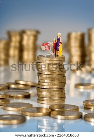 Euro coins and miniature people, mother with children and shopping cart on a pile of coins, inflation, price increase of supermarket goods and food Foto stock © 