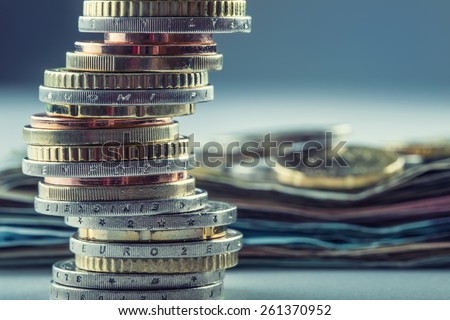 Euro coins stacked on each other in different positions.