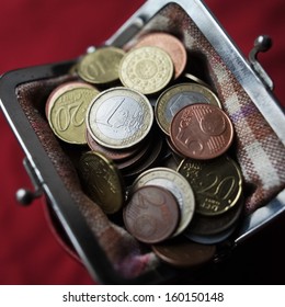 Euro coins in vintage wallet