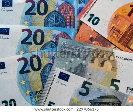 Euro currency banknote background made of paper banknotes of the euro. Denominations of €20, €10 and €5 notes. Issued by the national central banks of the Eurosystem or the European Central Bank.