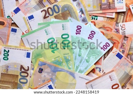 Euro currency banknotes background. European paper money backdrop with 50, 100 and 200 euros bills.