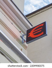 Euro Currency Sign On A Bulletin Board Against A Beige Building. Business Stock News Concept