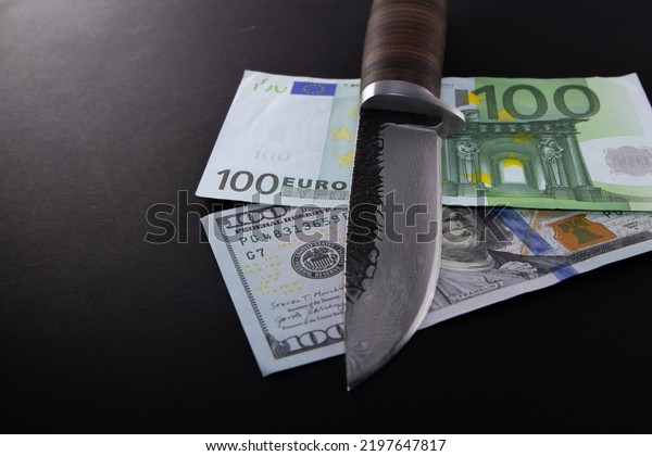 Euro Dollar Conflicts,\
banknote Dollar and banknote Euro, Euro vs Dollar a knife divided,\
Economic crisis