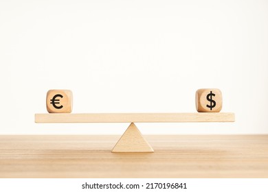 Euro and dollar parity concept. Dollar and euro symbol on wooden blocks on a seesaw. Copy space