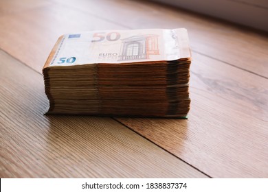 Euro money banknotes. Bundle of 50 euro bills on wooden table. Stack of euros banknotes, Money big wad packs
