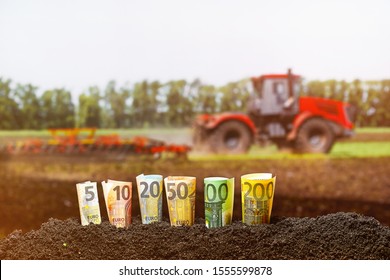 Euro Money. Different Euro Banknotes From 5 To 200 Euro On Agriculture Tractor Plowing Field Background. 