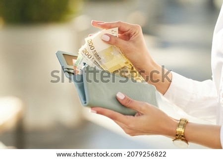 Euro Money. Female hands gets money from the wallet. Girl holding euro bills. Euro cash background.