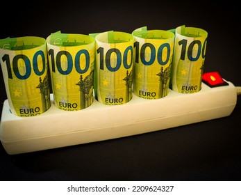 Euro Money Paper Banknotes Plugged Into A White Power Strip Over Black Bacground. Increasing Cost Of Electricity For Business Users And Residential Customers. Rise In Electricity Prices Concept