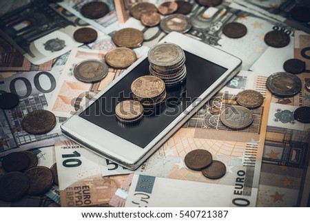 Euro money and phone. toned image