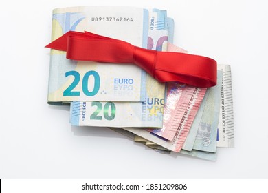 Euro Notes And Coins Decorated With Gift Bows; Give Away Money At Christmas Parties. When You Don't Know What To Give, You Give Money. The Best Gift, Give Money And Let Everyone Buy What They Want.