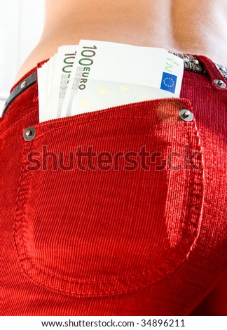 Euro in a pocket of red trousers of the woman