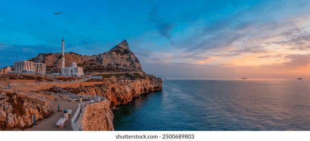 Europa Point Lighthouse with sea in background. Colorful Cloudy Sunrise Sky. Gibraltar, United Kingdom. Panorama. - Powered by Shutterstock